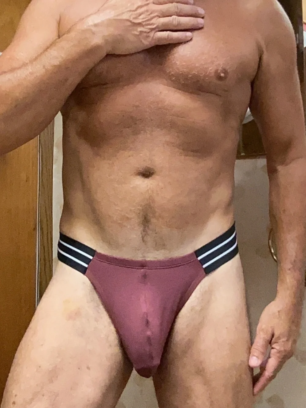 Sexy, burgendy color brief with black side straps.